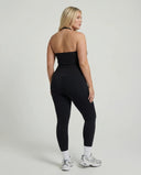 Model wearing a black seamless halter sculpt leggings set with high waist fitted leggings and athletic sneakers.