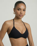 Model wearing a black seamless sculpt gym set with high waist shorts and a supportive sports bra paired with athletic sneakers.