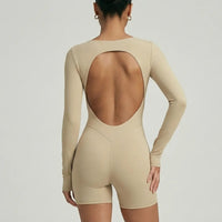 Woman wearing a long sleeve compression shorts sculpting romper designed for activewear and athleisure use.