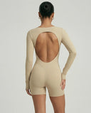 Woman wearing a long sleeve compression shorts sculpting romper designed for activewear and athleisure use.