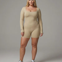 Woman wearing a long sleeve compression shorts sculpting romper designed for activewear and athleisure use.