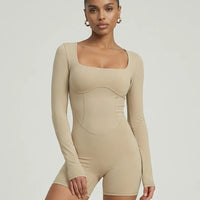 Woman wearing a long sleeve compression shorts sculpting romper designed for activewear and athleisure use.