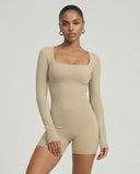 Woman wearing a long sleeve compression shorts sculpting romper designed for activewear and athleisure use.