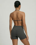 Model wearing a grey seamless sculpt gym set with high waist shorts and a supportive sports bra paired with athletic sneakers.