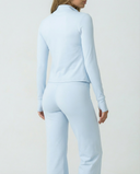 Women's Seen 3-piece flare pants, sports bra, and jacket set displayed on a hanger with a neutral background.