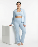 Women's 3-piece flare pants, sports bra, and jacket set by seen, shown in a stylish activewear outfit.