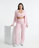 Women's 3-piece activewear set by seen featuring flare pants, a sports bra, and a matching jacket on a white background.
