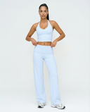 Seen flare yoga pants set with high waist and halter sports bra, shown in black on a model. Comfortable activewear for yoga and workouts.