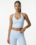 Seen flare yoga pants set with high waist and halter sports bra, featuring stretchy fabric and stylish design on a model.