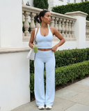 Seen flare yoga pants set with high waist and halter sports bra, showing the stylish black fabric and comfortable fit.