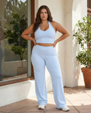 Seen flare yoga pants set with high waist and halter sports bra, featuring a stylish, comfortable activewear design.