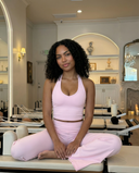 Seen flare yoga pants set with high waist and halter sports bra, featuring flowy pant legs and supportive athletic top.