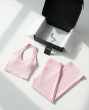 Seen flare yoga pants set with high waist and halter sports bra, shown in black with flare leg design and supportive fit.