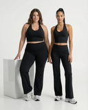 Seen flare yoga pants set with high waist and halter sports bra, featuring flare legs and supportive fit for active wear.