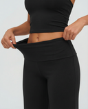 Seen flare yoga pants set with high waist and halter sports bra, featuring stylish flare leg design and comfortable fit.