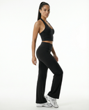 Seen flare yoga pants set with high waist and halter sports bra, shown in a stylish athletic pose on a white background.