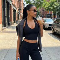 Seen women's sports top with halter neck, seamless sculpting fit, part of activewear set, designed for comfortable workout wear.
