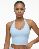 Seen women's sports top with halter neck, seamless sculpting fit, designed for active wear and comfortable support.