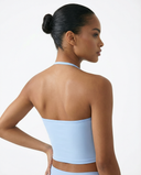 Seen women's sports top with halter neck, seamless design, and sculpting fit, shown on a white background.