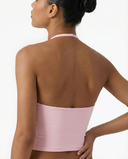 Seen women's sports top with halter neck, seamless design, and sculpting fit, shown in a close-up front view.