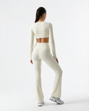 Seen women's flare yoga pants set with high waist and long sleeve crop top, designed for activewear and comfortable movement.