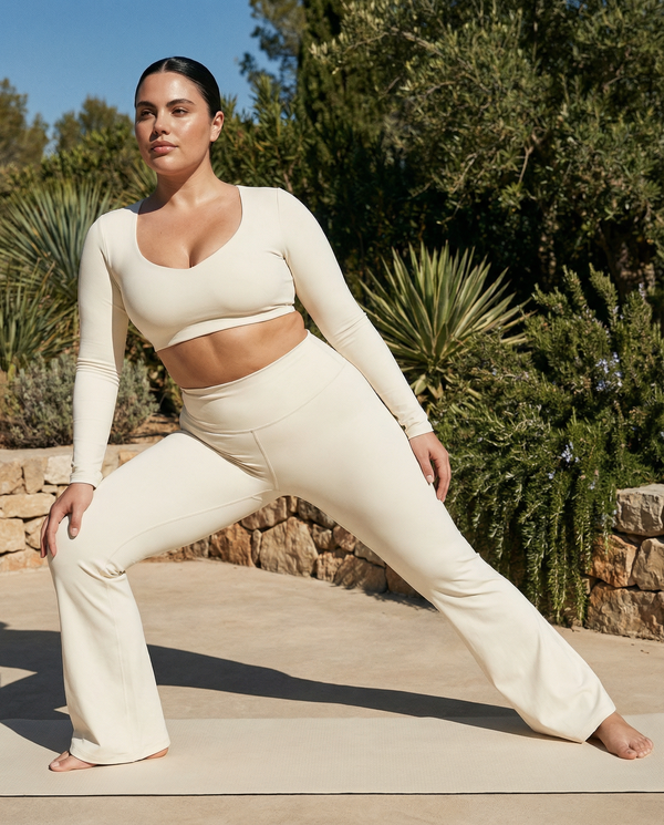 Seen women's flare yoga pants set with high waist and long sleeve crop top, shown in a stylish activewear outfit.