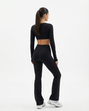 Seen flare yoga pants set with high waist and long sleeve crop top, featuring a stylish fit and comfortable stretch fabric.