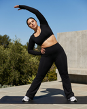 Seen flare yoga pants set with high waist and long sleeve crop top, featuring a fitted design and flared pant legs.