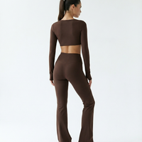 Seen flare yoga pants set featuring high waist and long sleeve crop top, shown in a stylish, comfortable athletic wear design.