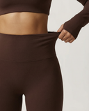 Seen flare yoga pants set with high waist and long sleeve crop top, featuring a stylish and comfortable athletic wear design.