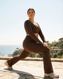 Seen flare yoga pants set with high waist and long sleeve crop top, showcasing the stylish, comfortable activewear in a natural pose.