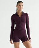 Seen women's activewear set with zip jacket and sculpting shorts, shown in a stylish, fitted workout outfit.