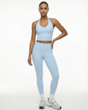 Seen high waist leggings set with sculpting fit and halter top, shown in black on a model against a white background.