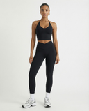 Seen high waist leggings set with sculpting fit and halter top, women's activewear ensemble in black on a white background.