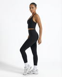 Seen high waist leggings set with sculpting fit and halter top, featuring black activewear with sleek, comfortable fabric.
