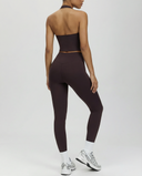 Seen women's high waist leggings set with sculpting fit and halter top, featuring black activewear with sleek design.