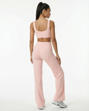 Seen women's activewear set featuring flare pants and a matching sports bra, shown on a model in a workout pose.