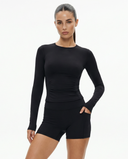 Seen women's workout set featuring a long sleeve top and biker shorts in a sleek, fitted design for active wear.