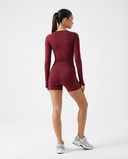Women's Seen activewear set with long sleeve top and biker shorts, perfect for workout and fitness activities.