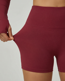 Seen women's activewear set featuring a long sleeve workout top and matching biker shorts in a sleek, athletic style.