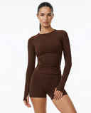 Seen women's workout set with long sleeve top and biker shorts, ideal activewear for fitness and casual wear.