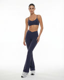 Seen women's flare yoga pants set with high waist leggings and matching sports bra, shown in a comfortable activewear outfit.