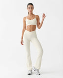 Seen women's flare yoga pants set with high waist leggings and matching sports bra, shown in a stylish activewear outfit.