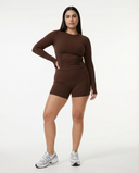 Seen women's workout set featuring a long sleeve top and biker shorts in breathable athletic fabric.