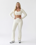 Seen women's flare yoga pants set with high waist and long sleeve crop top, designed for activewear and comfortable movement.
