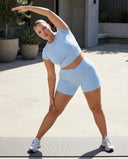 Seen SculptFit light blue women's activewear crop top and shorts set displayed on a model, perfect for workout or casual wear.
