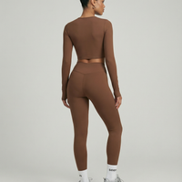 Seen women's activewear set featuring long sleeve top and high waist leggings, in breathable, stretchy fabric for workout comfort.