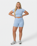 Seen SculptFit women's activewear crop top and shorts set in light blue, perfect for workout or casual wear.