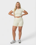 Seen women's activewear set featuring beige sculpt-fit crop top and shorts, designed for comfortable, stylish workouts.