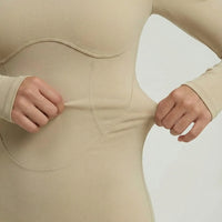 Woman wearing a long sleeve compression shorts sculpting romper designed for activewear and athleisure use.